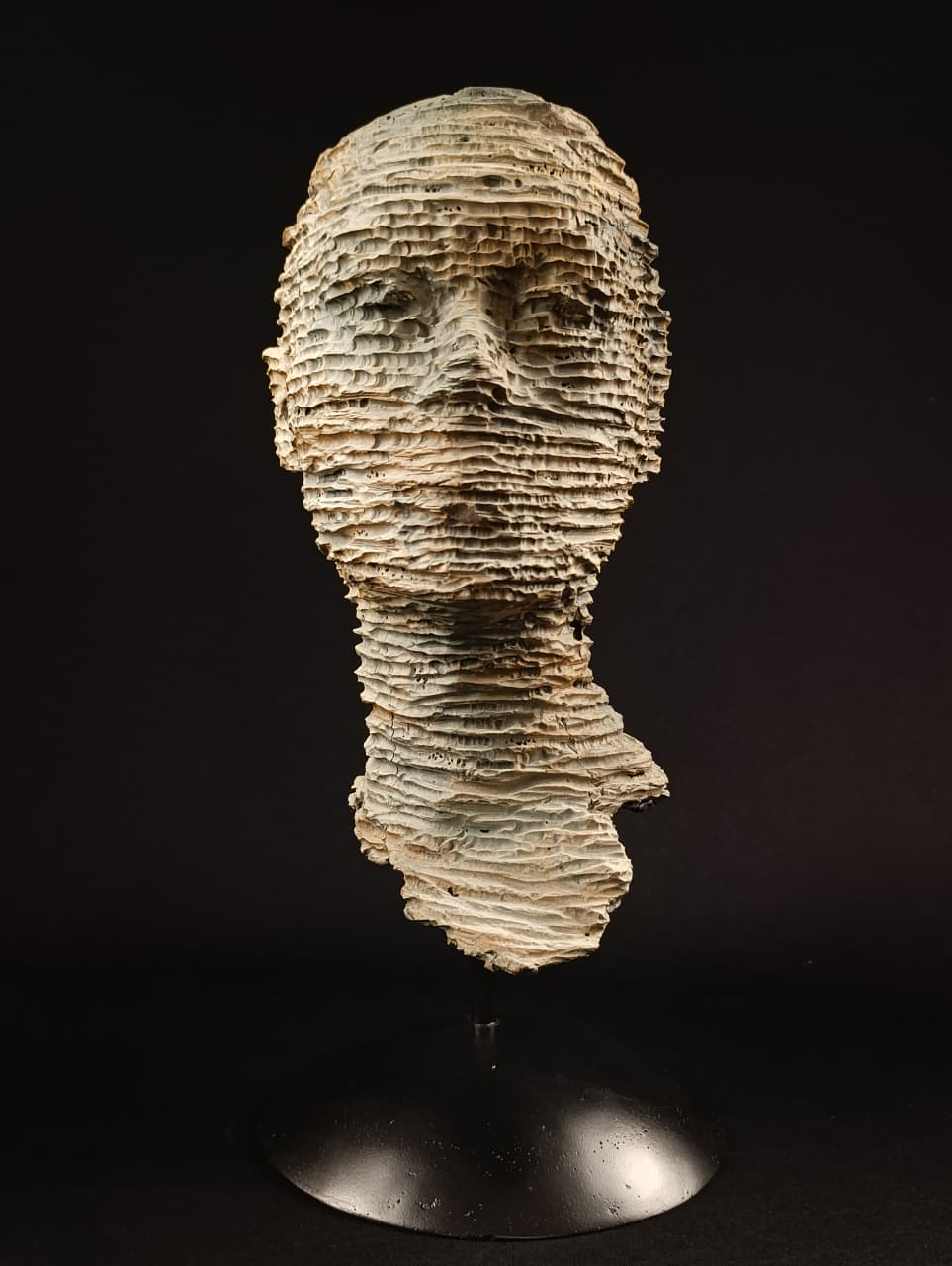 Parte inferior de la escultura en yeso que sostiene el busto fragmentado.